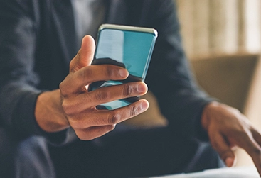 Businessman holding a cell phone. 